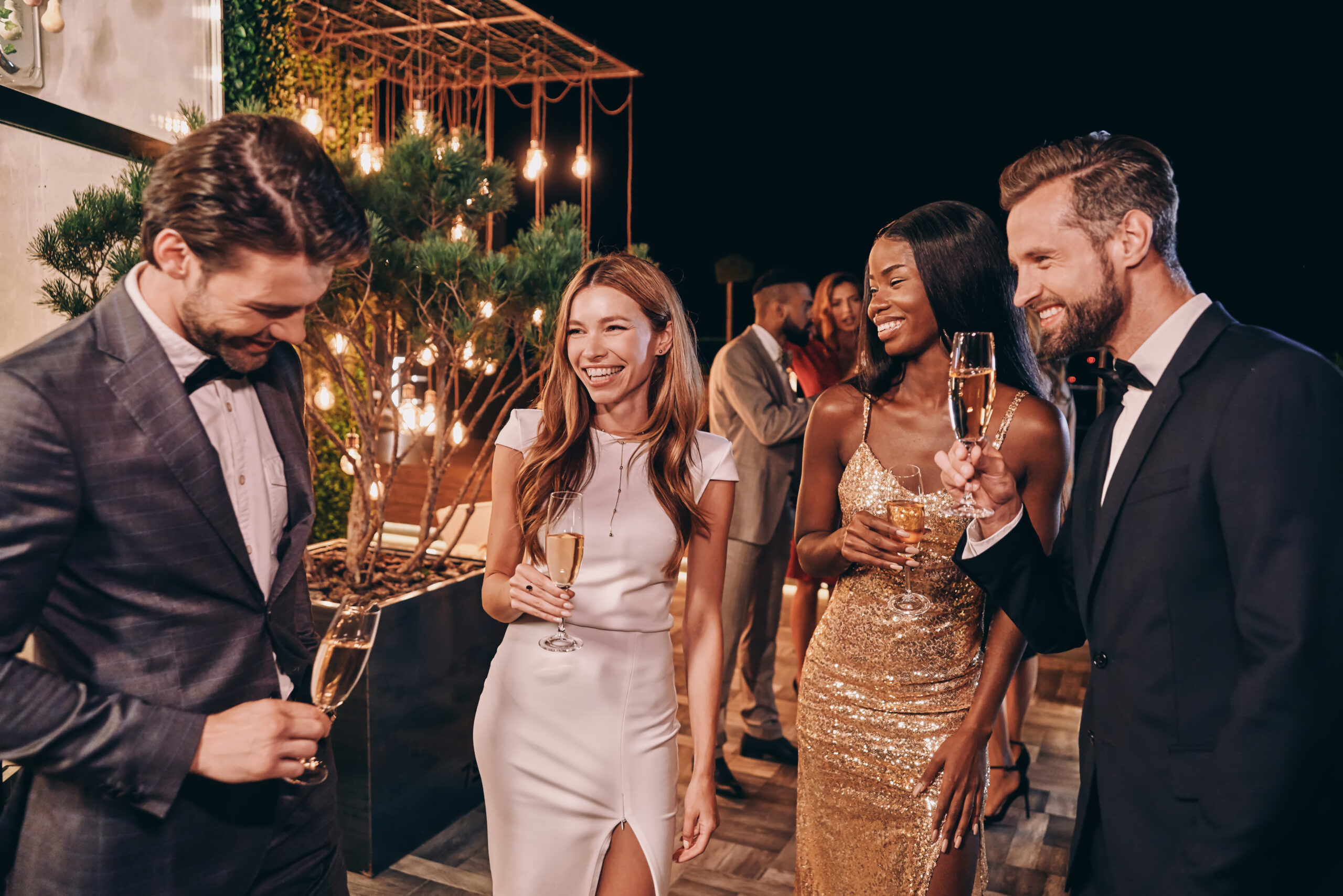 Group of beautiful people in formalwear communicating and smilin
